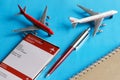 Toy passenger airliners next to an electronic air ticket on smartphone screen, notepad and pen. Selecting, purchasing and using an Royalty Free Stock Photo