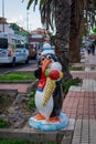 Toy penguin carries ice-cream on the street