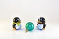Toy Penguins Looking At Xmas Ornament Royalty Free Stock Photo