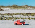 A toy pickup truck hauls a Christmas tree on New Smyrna Beach, Florida Royalty Free Stock Photo