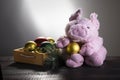 Toy pig next to box with New year balls on wooden surface. Festive card, Chinese New Year of Pig, Zodiac symbol 2019