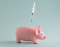 Toy pig with  syringe on  blue background. Science, vaccination concept Royalty Free Stock Photo