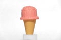 Toy pink ice cream in a cone on a top of table