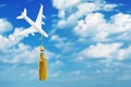 Toy plane and a bottle of whiskey on a background of sky with clouds. Concept on the topic of alcohol abuse on board an airplane Royalty Free Stock Photo