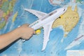 The toy plane flies by the geographical map