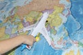 The toy plane flies by the geographical map