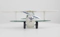 toy, plastic airplane with a propeller, without a pilot on a white background, turquoise brush, side view