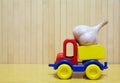 Toy plastic car with garlic Royalty Free Stock Photo
