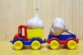 Toy plastic car with garlic Royalty Free Stock Photo
