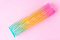 Toy plastic rainbow on a pastel pink background Royalty Free Stock Photo