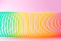 Toy plastic rainbow on a pastel pink background. Royalty Free Stock Photo