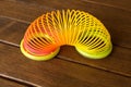 Toy plastic rainbow on a wooden table. Multi-colored spiral for