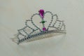 Toy plastic tiara on a white Board