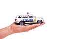 Toy police car on palm isolated on white background Royalty Free Stock Photo