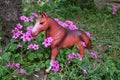 Toy pony among the flowers in the meadow