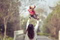 Toy Poodle playing with its female master in a park Royalty Free Stock Photo