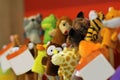 Toy puppets on wooden sticks for preschool nursery theatre, standing in a row.