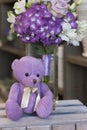 Toy purple Teddy bear sitting on a wooden box Royalty Free Stock Photo
