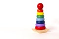 toy pyramid, wooden, multi - colored rings, on a white background