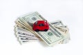 Toy red car and a stack of money dollar bills American dollars on a white isolated background. buy a car on credit. Royalty Free Stock Photo