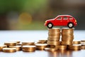 Toy red car top of a stack of coins on a table with bokeh background Royalty Free Stock Photo