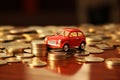 Toy red car top of a stack of coins on a table with dark background Royalty Free Stock Photo