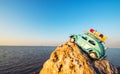 Toy retro car on rock by the sea