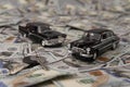 Toy retro cars on the background of dollar bills Royalty Free Stock Photo