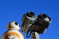 Toy robot fiends Sphero BB8 from Star Wars and LEGO Wall-E from Disney Pixar movie sunbathing on daylight sunshine,