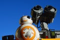 Toy robot fiends Sphero BB8 from Star Wars and LEGO Wall-E from Disney Pixar movie sunbathing on daylight sunshine,