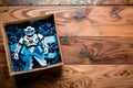 toy robot in a gift box with blue bow on wooden table Royalty Free Stock Photo