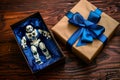 toy robot in a gift box with blue bow on wooden table Royalty Free Stock Photo