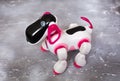 Toy robot white and pink, on a concrete background. The dog is a robot. Royalty Free Stock Photo