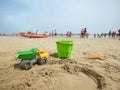 Toy sand truck with bucket and spade on an Italian beach Royalty Free Stock Photo