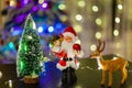 Toy Santa Claus against the background of light garlands Royalty Free Stock Photo