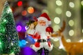 Toy Santa Claus against the background of light garlands Royalty Free Stock Photo