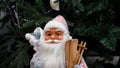 Toy Santa Claus with a bag of gifts on his shoulder and wooden skis. Royalty Free Stock Photo