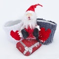 Toy Santa Claus with gifts in the snow. The concept of Christmas Royalty Free Stock Photo