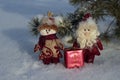 Toy Santa Claus and snowman with a gift on the snow Royalty Free Stock Photo