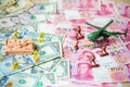 Toy set, tank, soldiers and helicopter placed on US banknotes,dollar currency pile and china banknotes