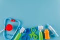 Toy set of tools for treatment, for playing doctor, toy stethoscope, hammer, syringe, pliers and pills, blue background Royalty Free Stock Photo