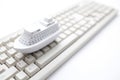 Toy ship on computer keyboard Royalty Free Stock Photo