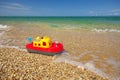 Toy ship on sea peble. Royalty Free Stock Photo