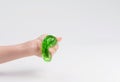 Slime in the hand of a child on a light background. The child plays with mucus and develops fine motor skills of the hands Royalty Free Stock Photo