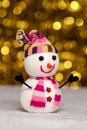 Toy snowman on a golden blurred background with bokeh Royalty Free Stock Photo