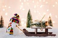 Toy snowman pulling small wooden sleigh Royalty Free Stock Photo