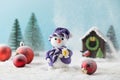 Toy snowman and red balls on fake snow near small house in decorative forest Royalty Free Stock Photo