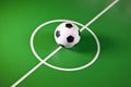 Toy soccer ball in a midfield, in the center of the green field Royalty Free Stock Photo