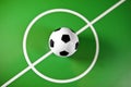 Toy soccer ball in a midfield, in the center of the green field Royalty Free Stock Photo