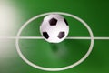 Toy soccer ball in a midfield, in the center of the green field Royalty Free Stock Photo